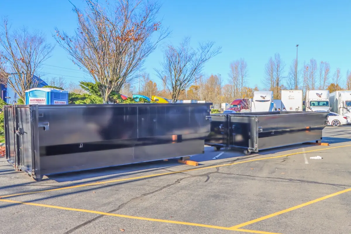 Professional dumpster rental service with roll-off container on residential driveway in Peachtree Corners